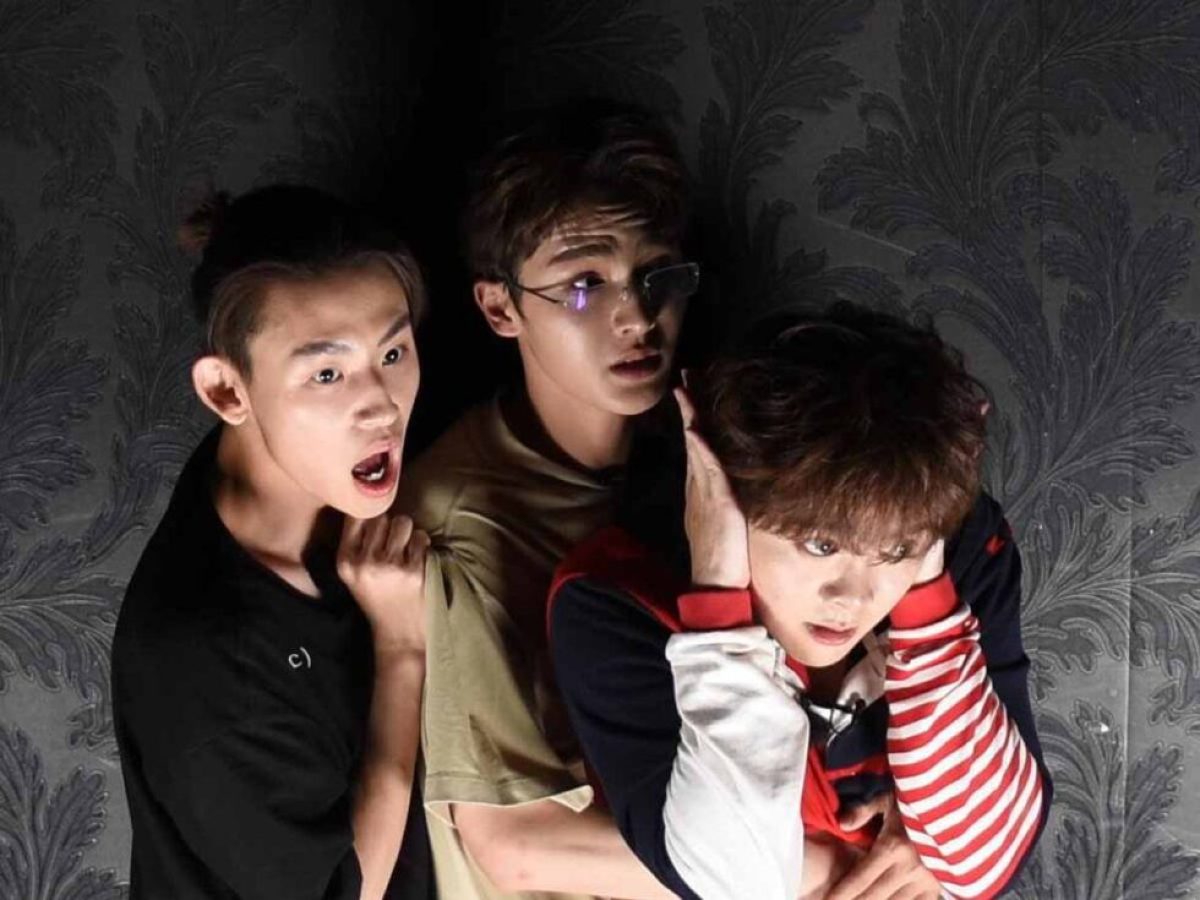 a group of young men standing next to a child