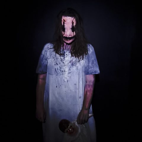 a man that is standing in the dark