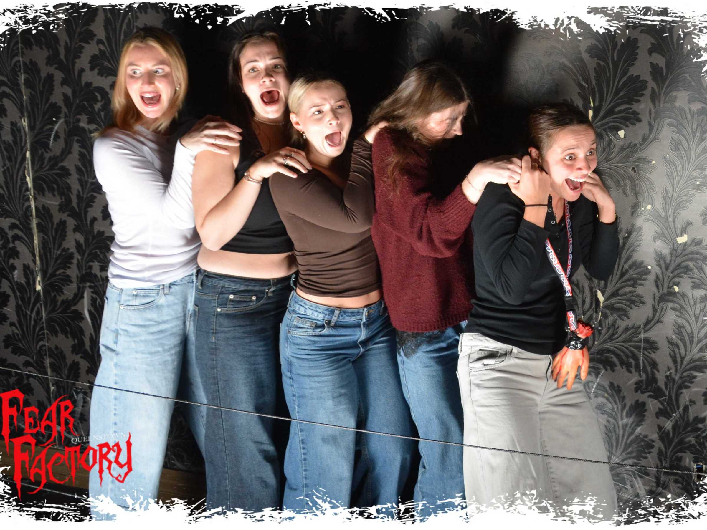 Five people standing in a row, reacting to something scary, with 'Fear Factory' text in the corner.